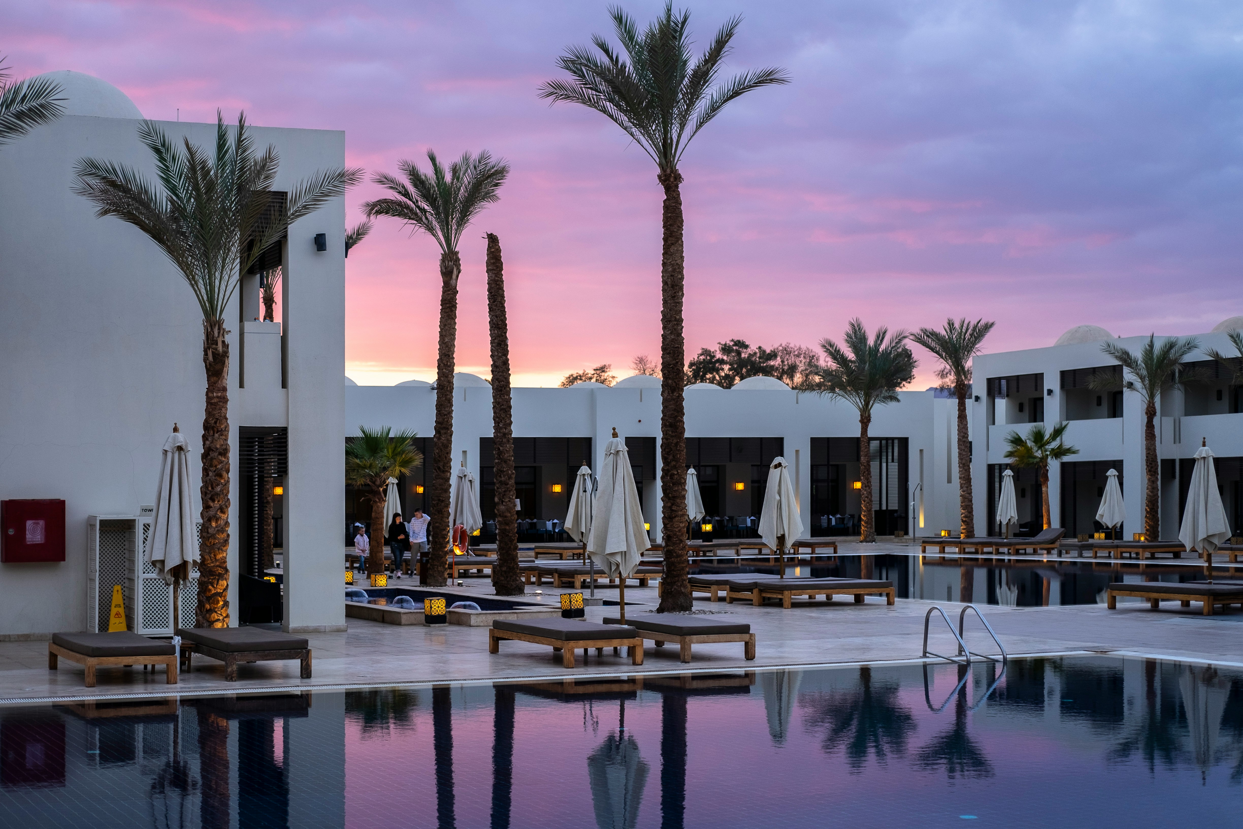 Hotel courtyard and pool at dusk